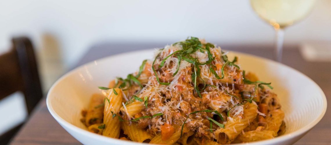 Bolognese and glass of wine