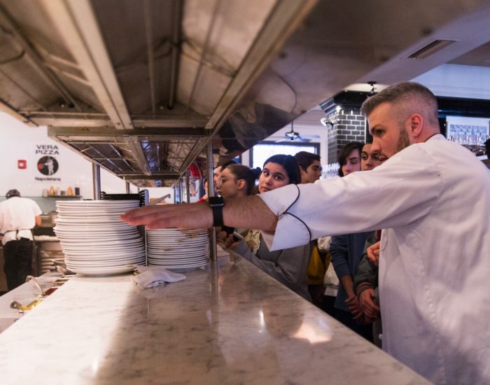 Picture of Avvio's Chef Greg Coccio teaching students 