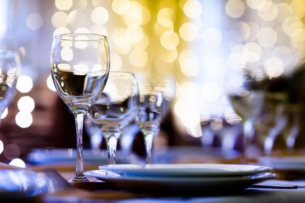 Low depth of the field image of empty wine, glasses, and plate plate plates