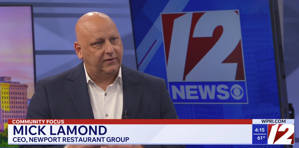 Mick Lamond, CEO of Newport Restaurant Group, speaks during a television interview with a news station.